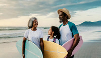senior african american couple and nephew kid walk the beach with surfboards at sunrise sky