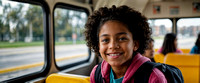joyful mixed race young girl sit on school bus , with backpack, classmates sitting in the background